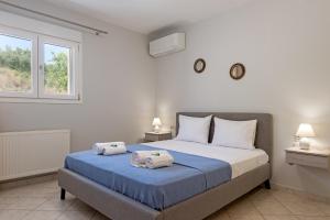 a bedroom with a bed with two towels on it at Lagadi Apartment 8 in Lassi