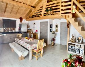 a kitchen and dining room with a table and chairs at chalet a la campagne in Coise-Saint-Jean-Pied-Gauthier