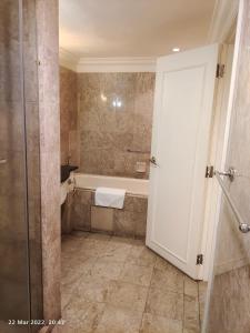 a bathroom with a shower and a tub and a toilet at Elias Suite KL Times Square Bukit Bintang in Kuala Lumpur