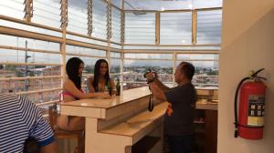a man taking a picture of two women at a bar at Tarapoto Hostal *** in Iquitos