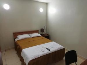 a bedroom with a large bed in a room at Tarapoto Hostal *** in Iquitos +7 photos