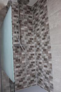 a shower with a hose in a bathroom at Gîte les Pervenches avec Sauna in Gérardmer +41 photos