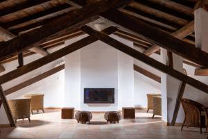 a room with chairs and a fireplace in a building at La Casa Grande in Talayuelas