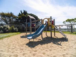 a playground with a slide in the sand at Camping 3 étoiles A La Corniche La Rochelle Angoulins in Angoulins-sur-Mer