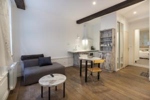 a living room with a couch and a table at Appartement R1 T2 Rodez Centre Historique in Rodez