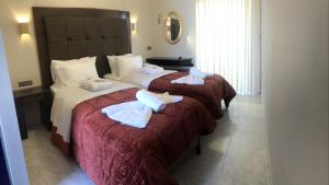 Postel nebo postele na pokoji v ubytování Ellinis Hotel
