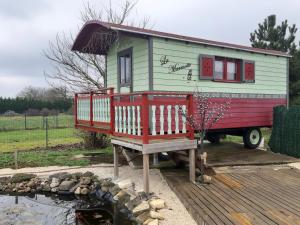 a tiny house sitting on the back of a truck at Roulotte La Marmotte in Poinson-lès-Fays