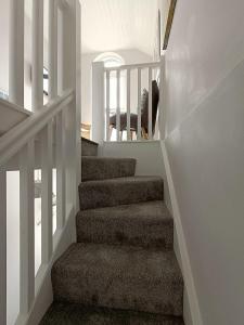 a staircase in a home with white walls at Beautiful 1-Bed Riversi Cottage Located in Malpas in Truro