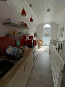 a kitchen with a sink and a counter top at Beautiful 1-Bed Riversi Cottage Located in Malpas in Truro