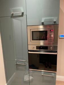 a microwave oven sitting inside of a refrigerator at London Central 2 minutes away from train station in London