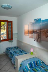A bed or beds in a room at Appartamento in residence Lighthouse