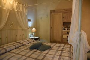 Postel nebo postele na pokoji v ubytování Agriturismo Poggio ai Legni