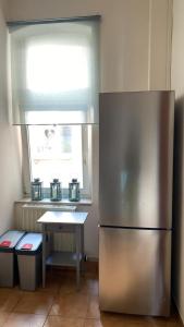 a kitchen with a stainless steel refrigerator and a table at Hotel Alt-Erfurt in Erfurt