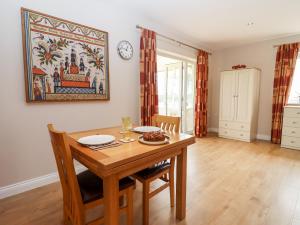 a dining room with a wooden table and chairs at Deer View in Witney