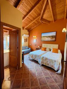 a bedroom with a large bed in a room at Hotel Doñana Blues in Matalascañas