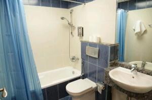 a bathroom with a toilet and a sink and a shower at Marina BestView 2 BedRoom Apartment in Dubai