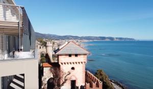 a view of the ocean from a building at Appartamenti Castello Borelli in Borghetto Santo Spirito