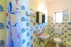 a bathroom with a toilet and a sink at Vista Mare Faros in Gaios