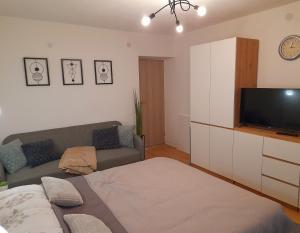 a living room with a couch and a flat screen tv at Apartman Roko in Gospić