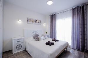 Ένα ή περισσότερα κρεβάτια σε δωμάτιο στο Palm Mar de LUX A31