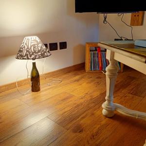 a lamp sitting on the floor next to a table at Casetta in Centro in Città di Castello +8 photos