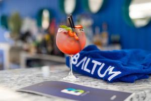 a drink in a martini glass sitting on a table at Hotel Baltum in Albufeira