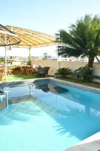 a swimming pool in a resort with a table and chairs at Troodon Park Hotel in Sousa