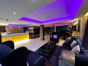 a living room with purple lighting and a couch at iCheck inn Nana by Aspira in Bangkok