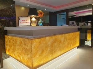a lobby with a counter with a sign on it at iCheck inn Nana by Aspira in Bangkok