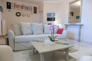 a living room with a couch and a table at Green House Ariadni in Artemida