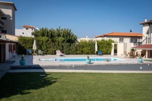 a swimming pool in a house with a yard at Green House Ariadni in Artemida