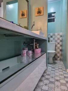 a bathroom with a sink and a toilet at Casa 170 in Belém