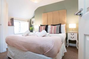 a bedroom with two beds and a window at Scarborough Stays - Luxury Townhouse Ideal for large groups - HOT TUB in Scarborough
