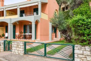 a house with a gate in front of it at Dimeli Junior Apartment at the beach in Barbati