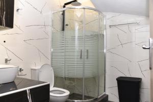 a bathroom with a glass shower with a toilet at Casa Galini in Kalamata +14 photos