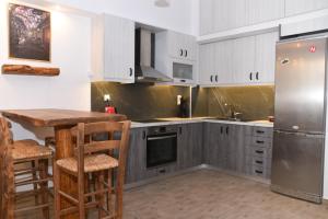 a kitchen with white cabinets and stainless steel appliances at Casa Galini in Kalamata
