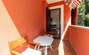 Habitación con balcón con sillas y mesa. en House Mitic en Rovinj