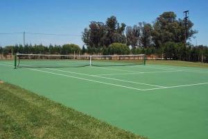 a tennis court with a net on top of it at La Posada del Indio in Mar del Plata