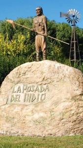 a statue of a man standing on top of a rock at La Posada del Indio in Mar del Plata