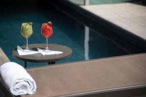 two wine glasses and a strawberry sitting on a table at Intercity BH Expo in Belo Horizonte