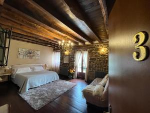 a bedroom with a bed and a chandelier at Casa Rural Irigoien in Donostia-San Sebastián