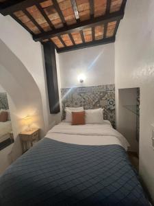 a bedroom with a large bed with a wooden ceiling at Fortaleza Suites Old San Juan in San Juan