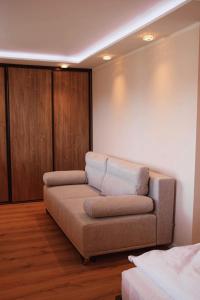 ein Wohnzimmer mit einem Sofa in einem Zimmer in der Unterkunft Apartament na Chopina 5 in Kołobrzeg
