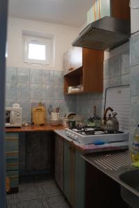 a kitchen with a sink and a stove top oven at Ostoja in Polańczyk