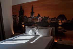 a bedroom with a bed with a painting on the wall at Hotel Seven Rooms in Milan