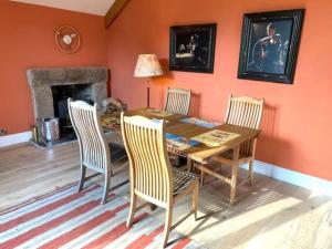 a dining room with a wooden table and chairs at Devon Country Paradise in Tavistock