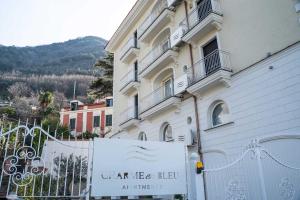 a building with a sign in front of it at Charme en Bleu in Castellammare di Stabia