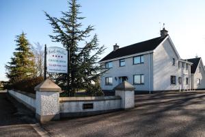 a white building with a sign in front of it at Keef Halla Country House in Crumlin