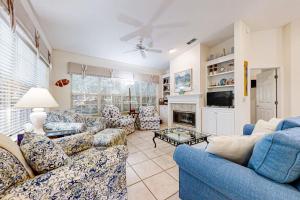 a living room with blue couches and a fireplace at 4954 Summer Beach Blvd in Fernandina Beach