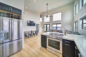 a kitchen with a stainless steel appliances and a living room at Modern Davenport Home with Water View and Grill! in Davenport